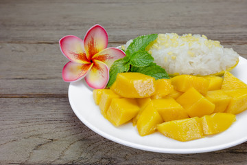 Ripe Mango with sticky rice on wood background