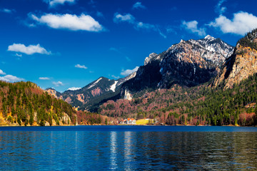 Blue Alpsee Lake in the Green Forest and Beautiful Alps Mountains. Fussen, Bavaria, Germany