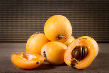 loquats on wooden background