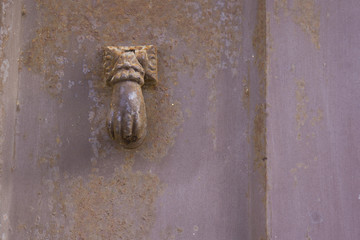 Old door knocker shaped by hand