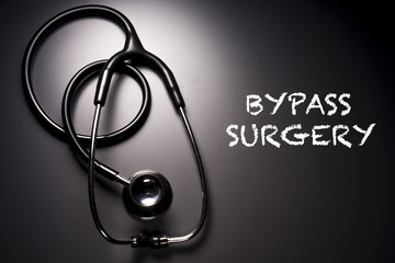 "Bypass Surgery" word with stethoscope on background - health concept. Medical conceptual