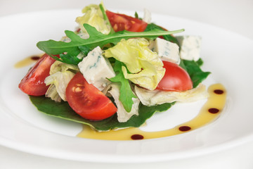 Fresh salad with spinach, cherry tomatoes, arugula and blue cheese. Close up image.