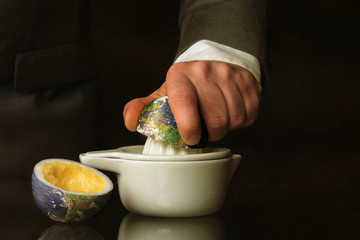 Businessman in a suit presses the Earth