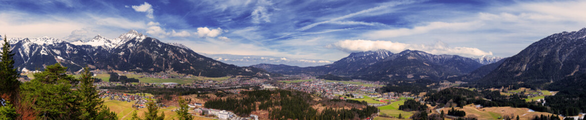 Fototapeta na wymiar Panoramic view of Reutte city with Alps and clouds, high resolution image. Alps, Tyrol, Austria.