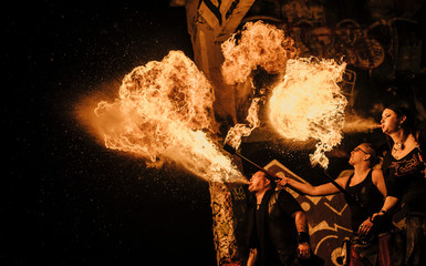 Performers fire breathing in urban area
