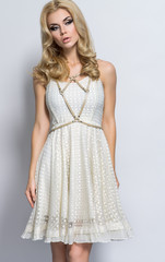 Naklejka premium Attractive blonde woman in beautiful white dress