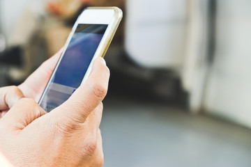 Close up image of businessman text messaging on his phone in subway,Social media life
