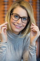 Young woman trying on glasses © eric