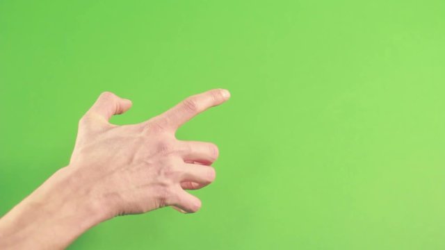 Hand isolated on green background. Human hand gesture isolated on green screen. Man hand on chroma key background pointing. Person wrist isolated in green studion