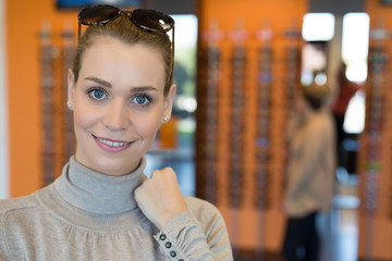 Woman trying on sunglasses in boutique