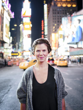 Portrait of smiling woman, Times Square, New York City, USA