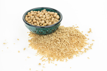 Soybeans in bowl and dry soya mince, isolated on white background.