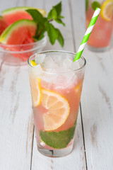 Fresh watermelon mojito on white wooden table
