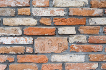Background. A brick wall with RIP brick