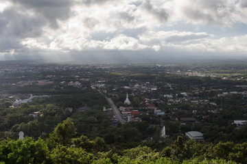 Fototapeta premium aerial top view of urban city with clouds and sun light reflect