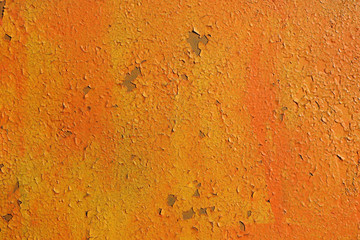 Old wall. The texture of the old shabby wall in orange tones.