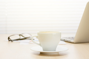 Office workplace with with laptop and coffee