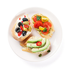 Toast sandwiches with avocado, tomatoes and olives