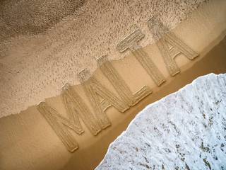 Malta written on the beach