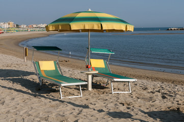 Rimini beach equipped with sun beds and umbrellas in the early morning summer