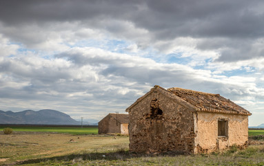 Old deserted barn in the meadow and hills of Andalusia, Spain