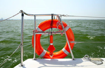 Lifebuoy on a yacht side. Concept of safe sea walk.