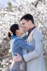 Fototapeta premium Attractive couple in blossoming park