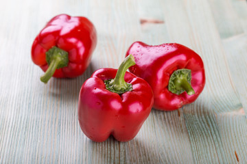 Fresh organic bell peppers on a wooden board
