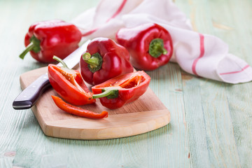 Fresh organic bell peppers on a wooden board