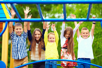 happy excited kids having fun together on playground © Olesia Bilkei