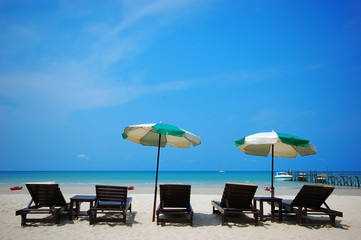 Beach chair and umbrella on sand beach