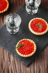 Traditional russian red caviare on the wooden table