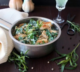 chicken in a creamy sauce with spinach and tarragon