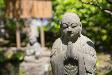 Stone Buddha in the garden of Japan Temple
