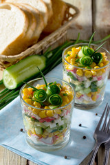 Salad with cucumber rolls in the form of roses (crab sticks, cor