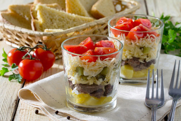 Salad with meat and vegetables on a wooden table, selective focu