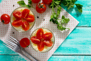 Salad with meat and vegetables on a wooden table, top view.