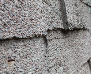 Grey wall constructed of the concrete blocks