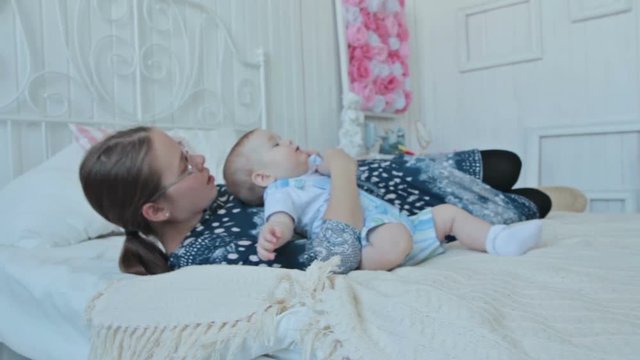 Mother and baby boy lying
