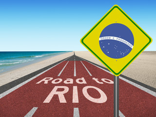 Road to Rio with Brazilian flag sign "Order and Progress" in English and beach