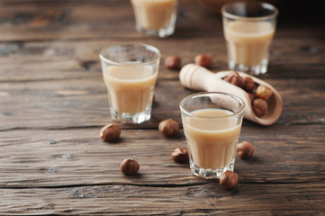 Traditional Italian hazelnut liqueur on the wooden table