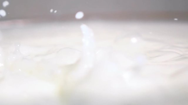 High-speed shot of churning milk in the bowl. 500 fps shooting with slow motion camera Sony rx 10 ii.
