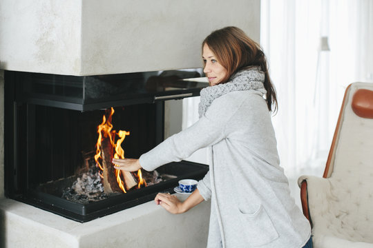 Woman near fireplace