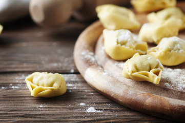 Italian traditional tortellini on the wooden table