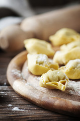 Italian homemade tortellini on the wooden table
