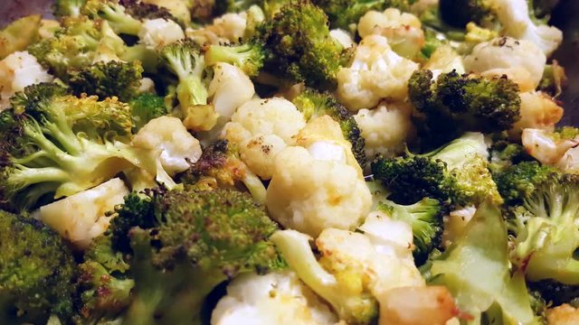 Oven baked, warm broccoli and cauliflowers, at a restaurant kitchen