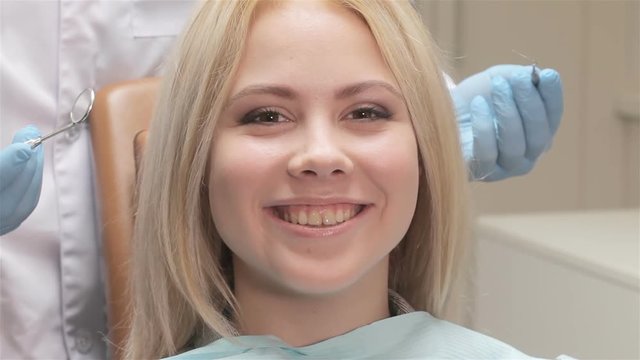 Closeup of dentist examines patient