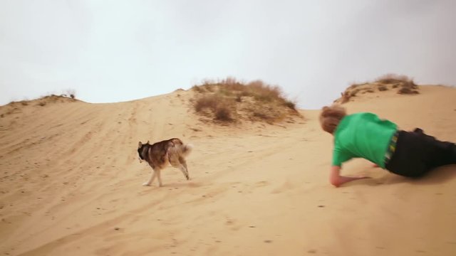 Kids playing and doing sport on sand. Slow motion
