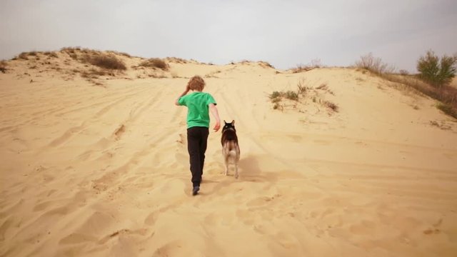 Kids playing and doing sport on sand. Slow motion