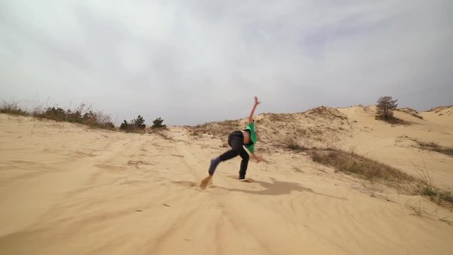 Kids playing and doing sport on sand. Slow motion